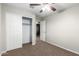 Bedroom with carpeted floors, a closet with sliding doors, and ceiling fan at 822 E Agua Fria Ln, Avondale, AZ 85323