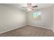 Bedroom features neutral walls, carpeted floors, a window, and a ceiling fan at 822 E Agua Fria Ln, Avondale, AZ 85323