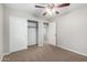 Bedroom featuring carpeted floors, a ceiling fan, closet and entry door at 822 E Agua Fria Ln, Avondale, AZ 85323