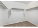 Walk-in closet featuring carpeted floors, white walls and shelving with racks at 822 E Agua Fria Ln, Avondale, AZ 85323