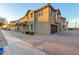 Attractive two-story home with a dark garage, tiled roof, and desert landscaping at 822 E Agua Fria Ln, Avondale, AZ 85323