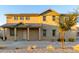 Charming two-story home featuring a cozy front porch with desert landscaping and a tiled roof at 822 E Agua Fria Ln, Avondale, AZ 85323