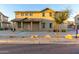 Charming two-story home featuring a cozy front porch with desert landscaping and a tiled roof at 822 E Agua Fria Ln, Avondale, AZ 85323