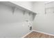 A bright laundry room with vinyl floors, shelves and a window at 822 E Agua Fria Ln, Avondale, AZ 85323