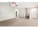 Bright and airy living space with neutral carpet, staircase, and an open doorway to a bathroom at 822 E Agua Fria Ln, Avondale, AZ 85323