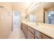 Bright bathroom featuring a double sink vanity with tile floors, large mirror, and shower at 9151 W Greenway Rd # 162, Peoria, AZ 85381