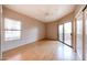 Well-lit bedroom featuring wood floors, a ceiling fan and sliding glass door at 9151 W Greenway Rd # 162, Peoria, AZ 85381