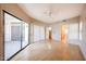 Spacious bedroom with wood floors, closet, ensuite bathroom, and sliding glass door at 9151 W Greenway Rd # 162, Peoria, AZ 85381