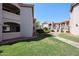 Exterior shot of a well-maintained community with grassy lawns, walkways, and mature landscaping at 9151 W Greenway Rd # 162, Peoria, AZ 85381