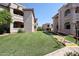 Lush courtyard featuring manicured lawns and mature landscaping with buildings in the background at 9151 W Greenway Rd # 162, Peoria, AZ 85381