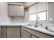 Stainless steel dishwasher and sink with granite countertops and view of a large window at 9151 W Greenway Rd # 162, Peoria, AZ 85381