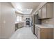 Bright kitchen features stainless steel appliances, granite countertops, and tile flooring at 9151 W Greenway Rd # 162, Peoria, AZ 85381