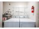 Functional laundry room with washer, dryer, shelving and water heater at 9151 W Greenway Rd # 162, Peoria, AZ 85381
