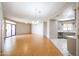 Open-concept living room with wood floors, ceiling fan, and sliding glass door leading to outdoor space at 9151 W Greenway Rd # 162, Peoria, AZ 85381