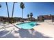 Lovely community pool with sparkling water, lounge chairs, and lush palm trees around the condos at 9151 W Greenway Rd # 162, Peoria, AZ 85381