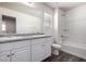 This bathroom features double sinks, grey countertops, wood floors and a shower/tub combo at 917 E Agua Fria Ln, Avondale, AZ 85323