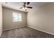 Bedroom featuring a ceiling fan and a large window at 917 E Agua Fria Ln, Avondale, AZ 85323
