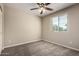 The carpeted bedroom features a window with blinds and a ceiling fan with lights at 917 E Agua Fria Ln, Avondale, AZ 85323