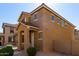 Two-story home with a covered entry and desert landscaping featuring warm earthy tones and architectural details at 917 E Agua Fria Ln, Avondale, AZ 85323