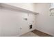 This laundry room features a shelf, white walls and wood look vinyl flooring at 917 E Agua Fria Ln, Avondale, AZ 85323