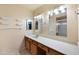 Well-lit bathroom with dual mirrors, clean countertops, and ample storage space at 9313 W Morrow Dr, Peoria, AZ 85382