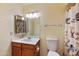 Bathroom featuring a mirror with lighting, a commode, and a shower with a cute animal-themed shower curtain at 9313 W Morrow Dr, Peoria, AZ 85382
