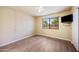 Bright bedroom featuring a large window with desert views and light wood flooring at 9313 W Morrow Dr, Peoria, AZ 85382
