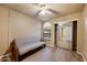 Bedroom with hardwood floors, closet with mirror doors, ceiling fan, and arched window providing natural light at 9313 W Morrow Dr, Peoria, AZ 85382