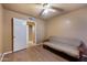 Inviting bedroom with hardwood floors, ceiling fan, and a futon, offering a cozy and relaxing space at 9313 W Morrow Dr, Peoria, AZ 85382