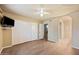 Spacious bedroom featuring modern floors, closet with mirrored doors, and view to adjacent rooms at 9313 W Morrow Dr, Peoria, AZ 85382