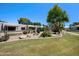 Beautifully landscaped community grounds featuring desert plants and a lush lawn at 9313 W Morrow Dr, Peoria, AZ 85382