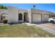 Charming single-story home featuring a well-manicured lawn and attached two-car garage at 9313 W Morrow Dr, Peoria, AZ 85382