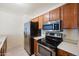 Close-up of kitchen featuring stainless steel appliances and light countertops and cabinetry at 9313 W Morrow Dr, Peoria, AZ 85382
