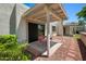 Cozy covered patio features outdoor seating and a serene view of the surrounding greenery at 9313 W Morrow Dr, Peoria, AZ 85382