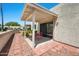 Private covered patio with a brick-lined walkway and a sliding glass door at 9313 W Morrow Dr, Peoria, AZ 85382