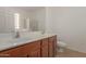 A neutral-toned bathroom featuring dual sinks, a full mirror, and a separate shower and toilet area at 10009 W Raymond St, Tolleson, AZ 85353