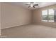 Neutral bedroom with carpet, ceiling fan, and a window with blinds at 10009 W Raymond St, Tolleson, AZ 85353