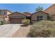 Charming single-story home featuring a two-car garage and low-maintenance desert landscaping at 10009 W Raymond St, Tolleson, AZ 85353