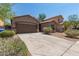 Inviting exterior of a one-story home featuring a spacious driveway and low-maintenance landscaping at 10009 W Raymond St, Tolleson, AZ 85353
