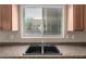 Kitchen sink located under a window providing natural light and scenic views at 10009 W Raymond St, Tolleson, AZ 85353