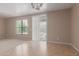 Spacious living room with neutral walls, tile and carpet flooring, and a window with bright natural light at 10009 W Raymond St, Tolleson, AZ 85353