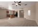 Open concept living area adjacent to the kitchen, featuring neutral tones and carpet flooring at 10009 W Raymond St, Tolleson, AZ 85353