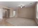 Spacious living room with carpet and tile flooring, and neutral color palette at 10009 W Raymond St, Tolleson, AZ 85353