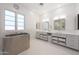 Modern bathroom features a free-standing metal tub, dual vanities, and stylish lighting at 10152 E Phantom Way, Scottsdale, AZ 85255