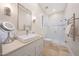 Bright bathroom with a sleek vanity, a vessel sink and a frameless glass shower at 10152 E Phantom Way, Scottsdale, AZ 85255
