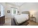 A bright bedroom featuring a patterned rug, bedside table, and large window at 10152 E Phantom Way, Scottsdale, AZ 85255