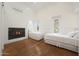 Bright bedroom featuring hardwood floors, fireplace and natural light from two windows at 10152 E Phantom Way, Scottsdale, AZ 85255