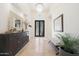 Grand entry with travertine floors, chandelier, console table and a view of the decorative front door at 10152 E Phantom Way, Scottsdale, AZ 85255