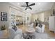Bright living room with a ceiling fan, views to the kitchen, and a set of office furniture at 10152 E Phantom Way, Scottsdale, AZ 85255