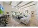 Bright and airy living room with high ceilings, a ceiling fan, and sliding glass doors to the back patio at 10152 E Phantom Way, Scottsdale, AZ 85255